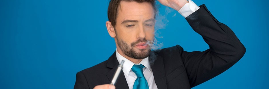 A confused man in a business suit looking at an electronic cigarette, also known as vape pen