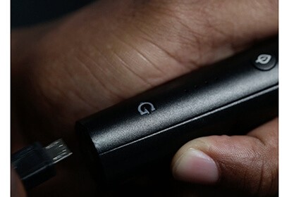 G pen pro vaporizer charging while held in a hand