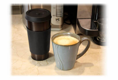 Vapor Cup vaporizer next to a coffee mug with coffee inside