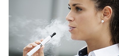 Young Beautiful Brunette Vaping smoke with her Vape Pen