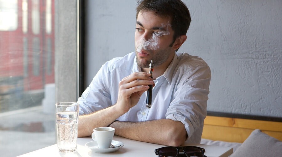 Young man smoking a vaporizer