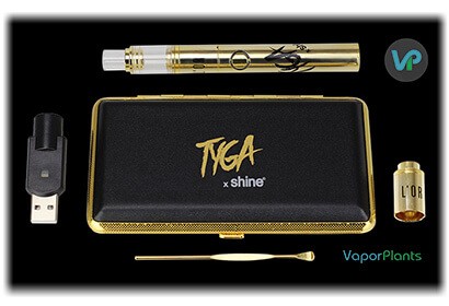 Atmos L'Or in gold next to usb charger, loading tool for wax and carrying case