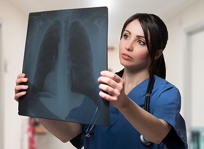 Nurse is examining a lungs radiology chart