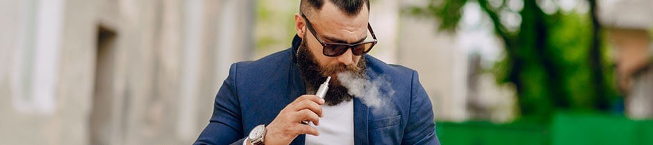 Bearded man is holding a weed vaporizer pen