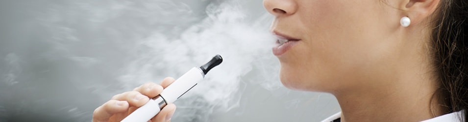 Woman's Lips releasing Vapor while using Vapor Pen